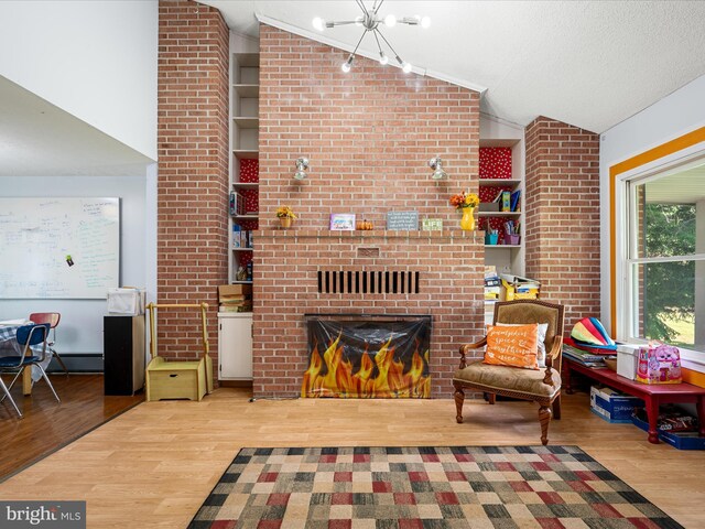 4137 Hedgesville Rd, Hedgesville, WV 25427 - living area with vaulted ceiling, wood finished floors, a brick fireplace, and a chandelier