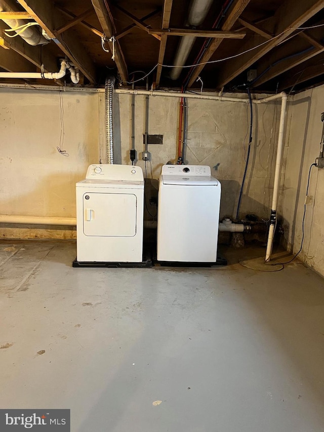 unfinished basement featuring washing machine and dryer