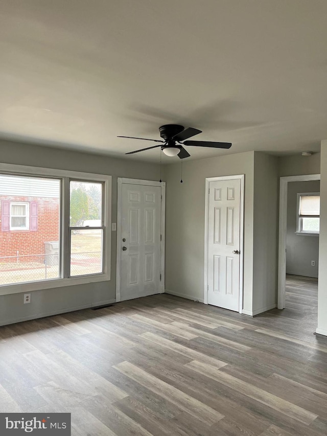 entrance foyer featuring baseboards, wood finished floors, and a ceiling fan