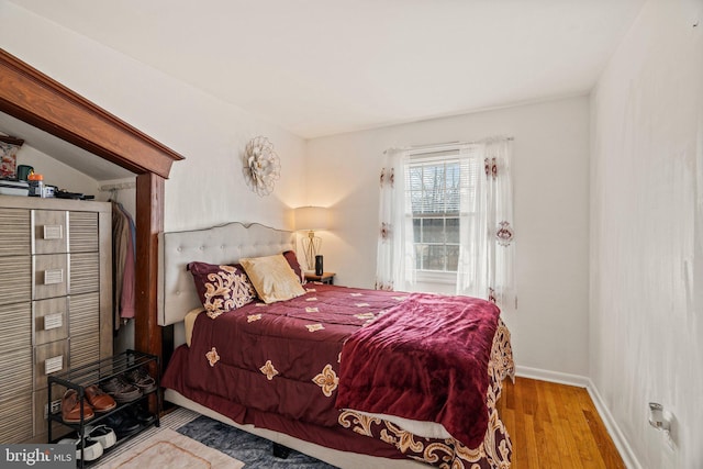 bedroom featuring wood finished floors and baseboards