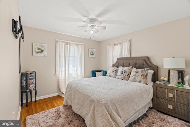 bedroom with wood finished floors, baseboards, and ceiling fan