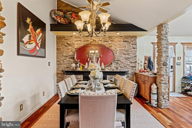 dining room featuring baseboards, a notable chandelier, and wood finished floors