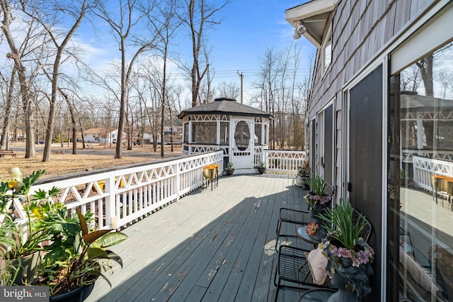 wooden terrace featuring a gazebo