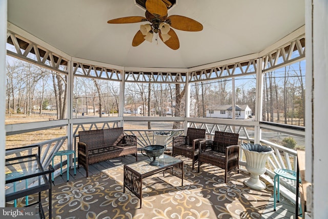 sunroom / solarium featuring ceiling fan