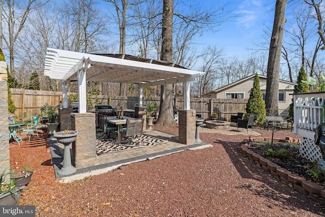 view of yard featuring a patio, a fenced backyard, a pergola, and an outdoor fire pit