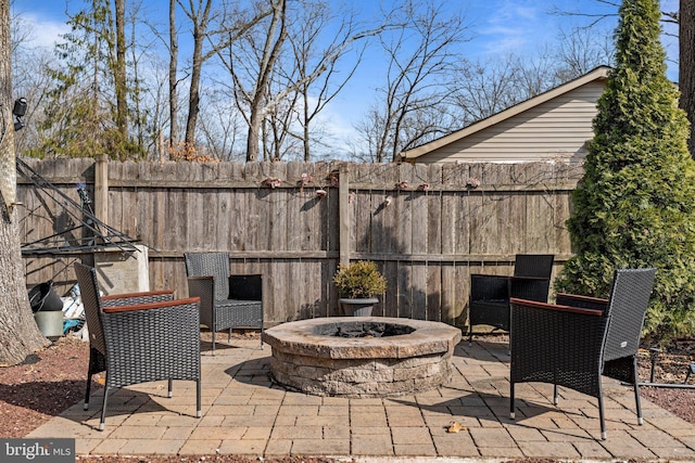 view of patio featuring fence and an outdoor fire pit