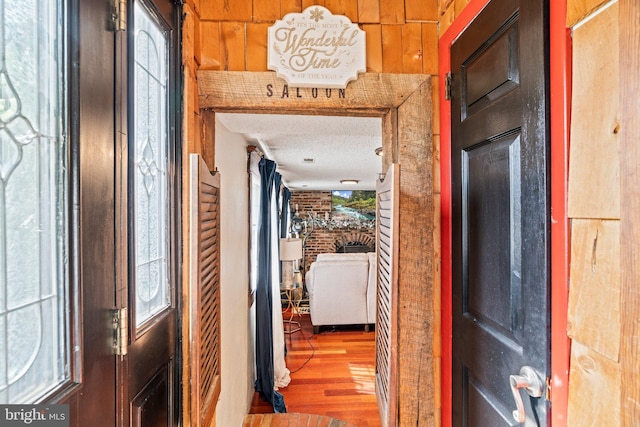 hall featuring wood finished floors and a textured ceiling