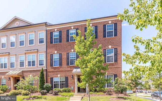 townhome / multi-family property with brick siding
