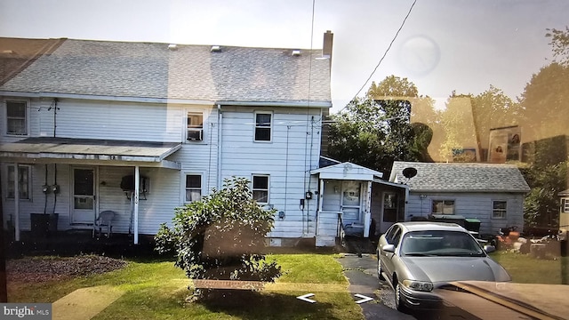 multi unit property with covered porch and a shingled roof