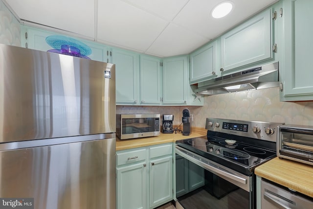 kitchen with under cabinet range hood, a toaster, and appliances with stainless steel finishes