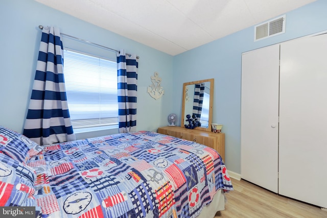 bedroom with wood finished floors and visible vents