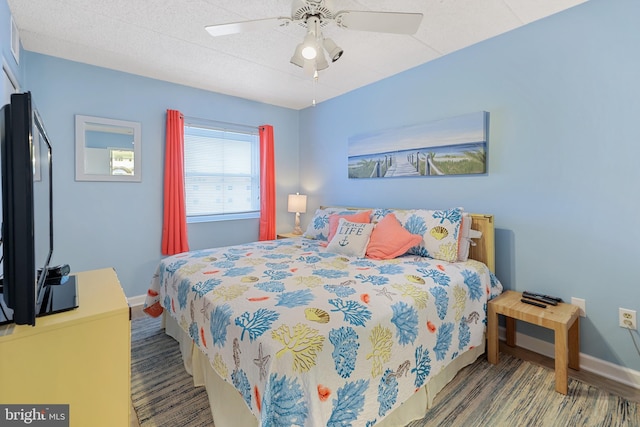 bedroom with baseboards and ceiling fan