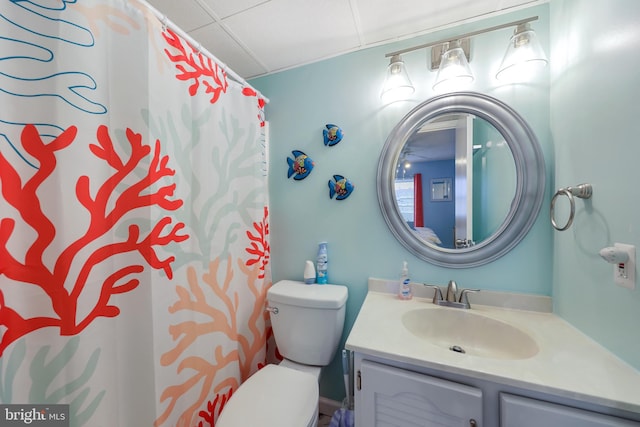 bathroom featuring vanity, curtained shower, and toilet