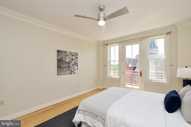 1210 R St NW Unit 313, Washington, DC 20009 - bedroom with access to outside, crown molding, baseboards, wood finished floors, and multiple windows