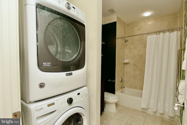 1210 R St NW Unit 313, Washington, DC 20009 - washroom featuring estacked washer and dryer and light tile patterned flooring