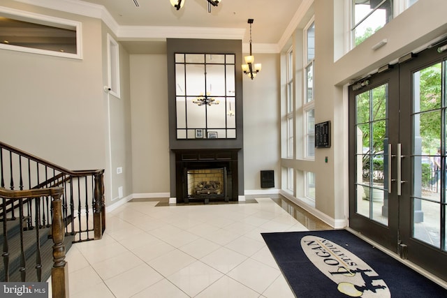 1210 R St NW Unit 313, Washington, DC 20009 - unfurnished living room with french doors, a chandelier, tile patterned floors, ornamental molding, and a towering ceiling