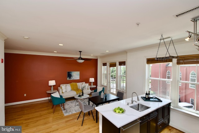 1210 R St NW Unit 313, Washington, DC 20009 - kitchen featuring a sink, stainless steel dishwasher, light countertops, ornamental molding, and ceiling fan
