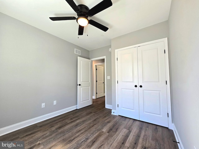211 Greenland Beach Rd, Baltimore, MD 21226 - unfurnished bedroom with visible vents, baseboards, dark wood-style floors, and a closet