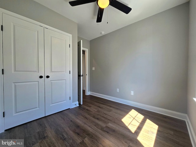 211 Greenland Beach Rd, Baltimore, MD 21226 - unfurnished bedroom featuring a ceiling fan, baseboards, dark wood finished floors, and a closet