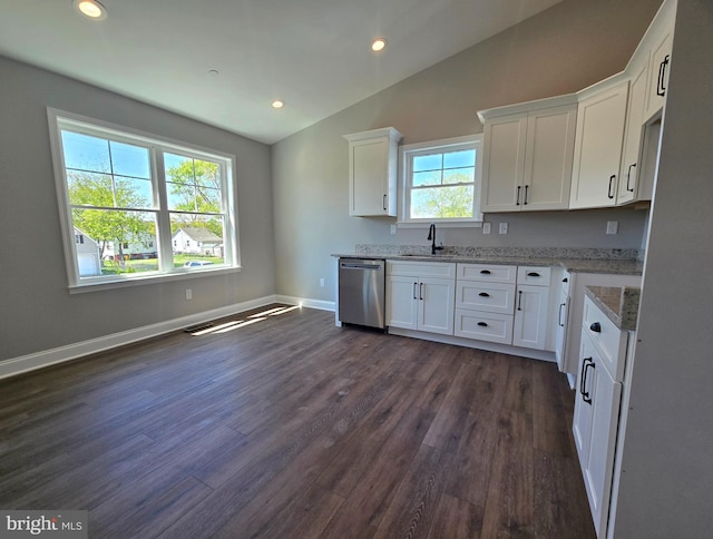 211 Greenland Beach Rd, Baltimore, MD 21226 - kitchen featuring light stone countertops, vaulted ceiling, dishwasher, dark wood-style floors, and white cabinetry