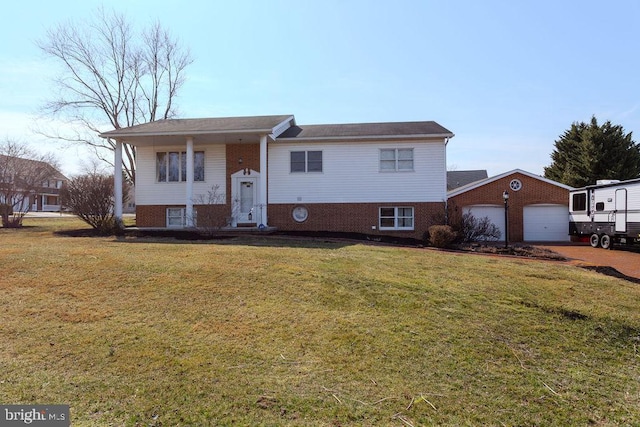 raised ranch with a garage, brick siding, and a front yard