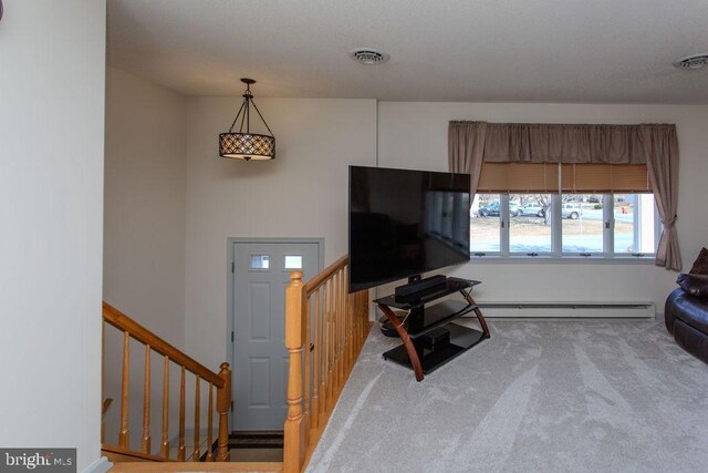 carpeted living area featuring stairs, visible vents, and a baseboard radiator