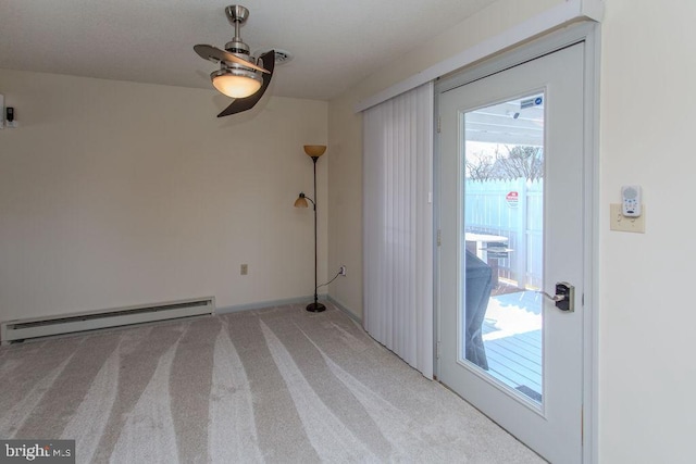 unfurnished room featuring baseboard heating, light colored carpet, and ceiling fan