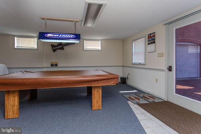 rec room with tile patterned flooring, billiards, a wainscoted wall, and a textured ceiling