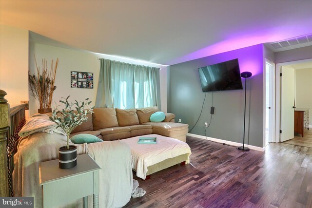 living room with visible vents, baseboards, and dark wood-style floors
