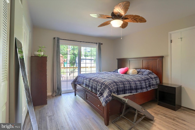 bedroom with light wood-type flooring, a ceiling fan, and access to exterior