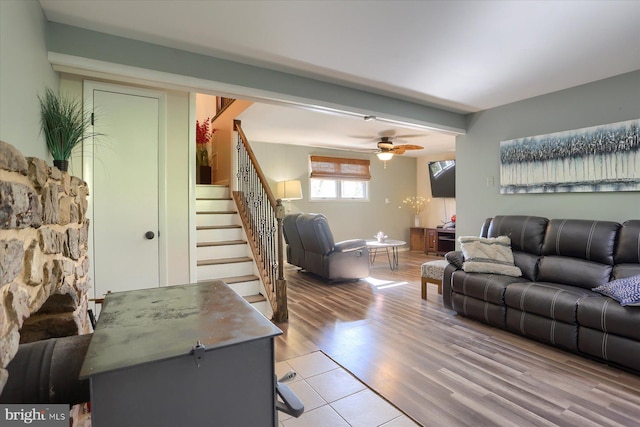 living room featuring ceiling fan, stairs, and wood finished floors