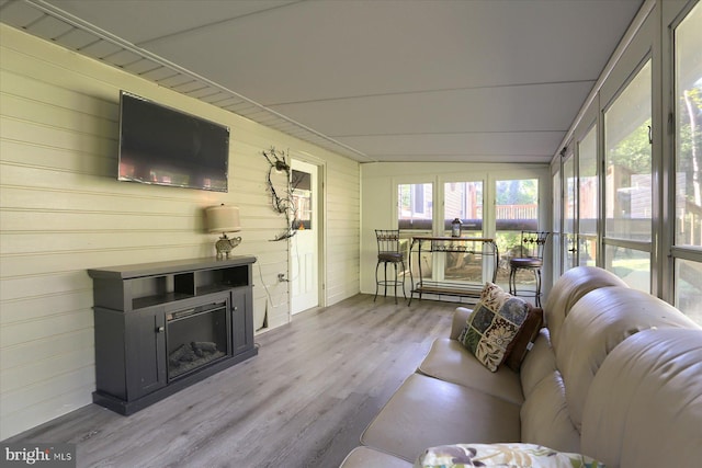 sunroom featuring wood walls and wood finished floors
