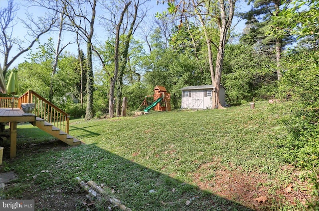 view of yard with a deck, an outbuilding, stairs, and a storage unit