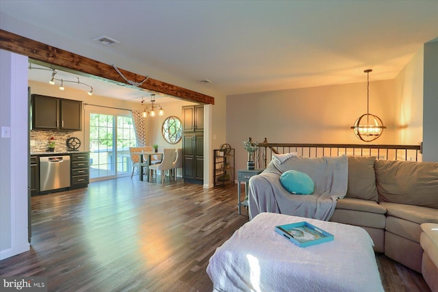 living area with dark wood-style flooring, baseboards, a notable chandelier, and visible vents