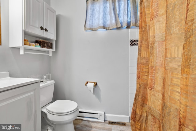 bathroom featuring vanity, visible vents, baseboards, a baseboard heating unit, and toilet