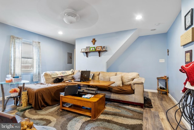 living area with baseboards, electric panel, recessed lighting, wood finished floors, and a ceiling fan