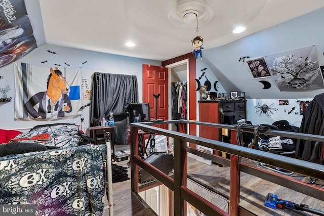 bedroom with recessed lighting and wood finished floors