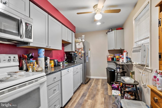 kitchen featuring cooling unit, a ceiling fan, light wood finished floors, a sink, and appliances with stainless steel finishes