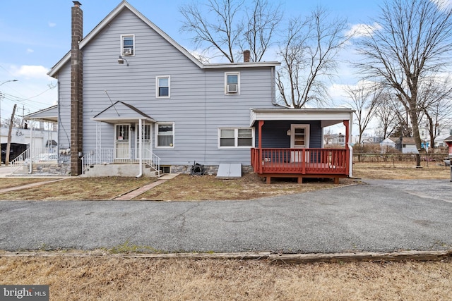 view of front of house with aphalt driveway and a chimney