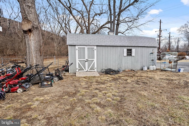 view of shed featuring fence