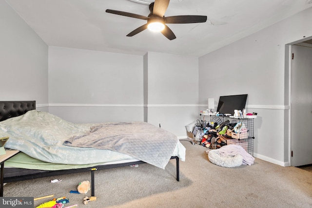 carpeted bedroom with a ceiling fan and baseboards