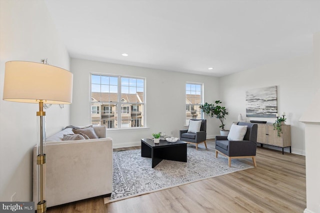 living room featuring recessed lighting, baseboards, and wood finished floors