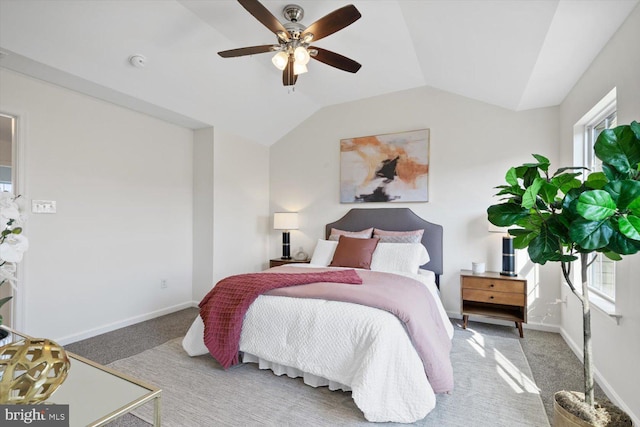 bedroom with vaulted ceiling, baseboards, and carpet floors