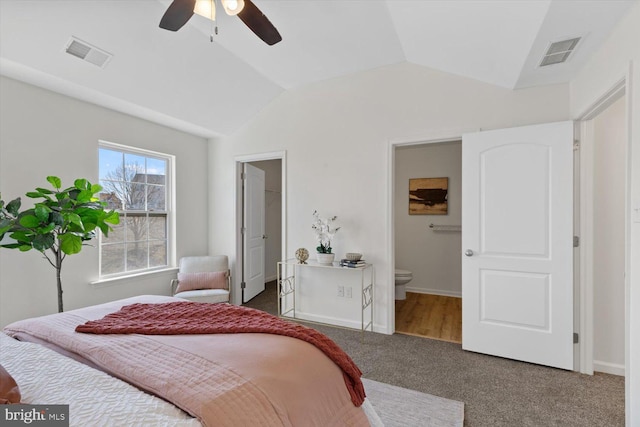 bedroom with visible vents, baseboards, carpet, and lofted ceiling