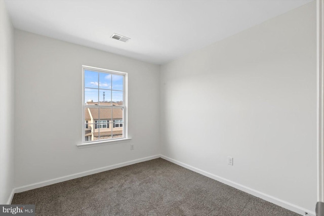 unfurnished room with baseboards, visible vents, and carpet floors