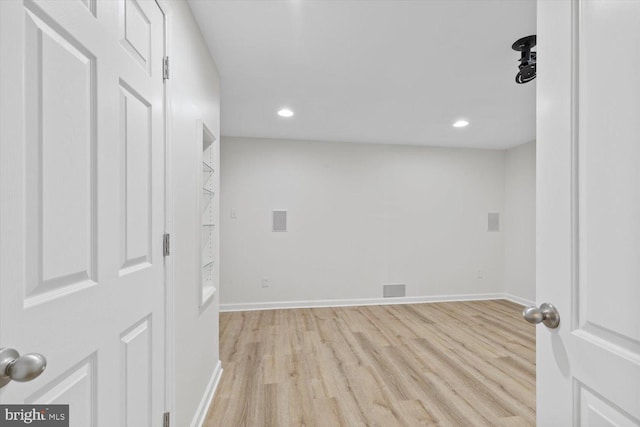 unfurnished room with recessed lighting, baseboards, and wood finished floors