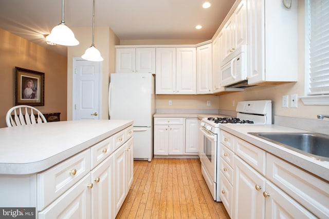 83 Huntington Dr, Jackson, NJ 08527 - kitchen featuring light countertops, light wood-style floors, white cabinets, white appliances, and a sink