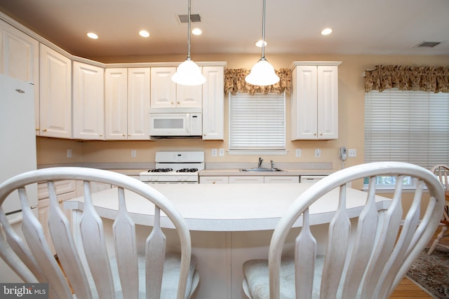 83 Huntington Dr, Jackson, NJ 08527 - kitchen with visible vents, a sink, recessed lighting, white appliances, and a breakfast bar area