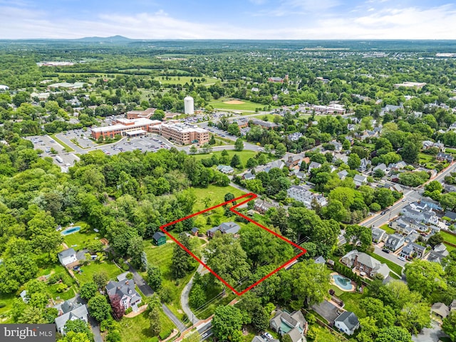 aerial view of property and surrounding area featuring property parcel outlined
