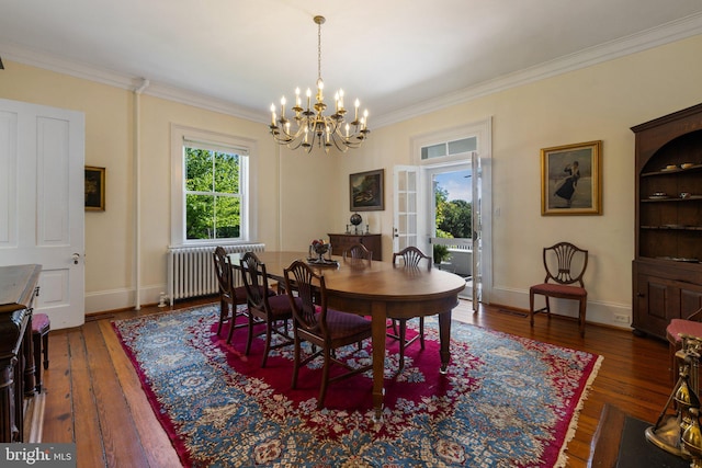 dining area with radiator, a chandelier, ornamental molding, wood-type flooring, and baseboards